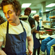 Jeremy Allen White stands in the kitchen.